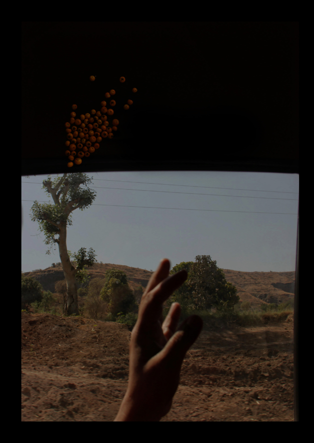 Hand in front of window, landscape scene behind