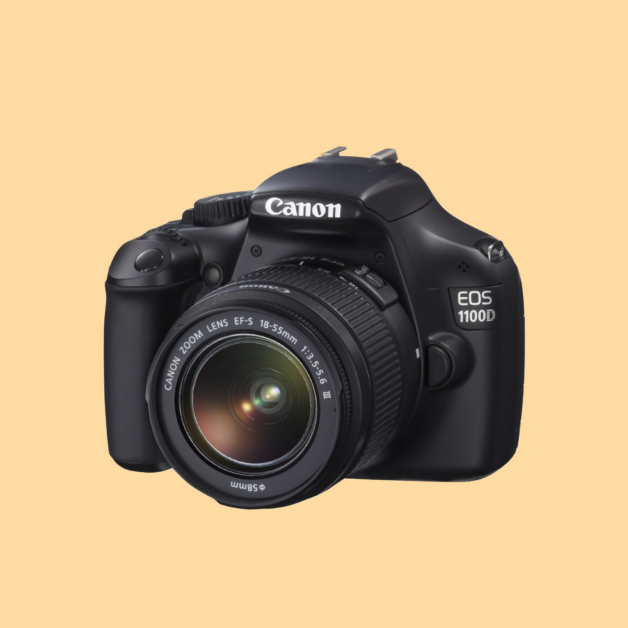 A photograph of a Canon 1100D DSLR camera against a warm yellow camera