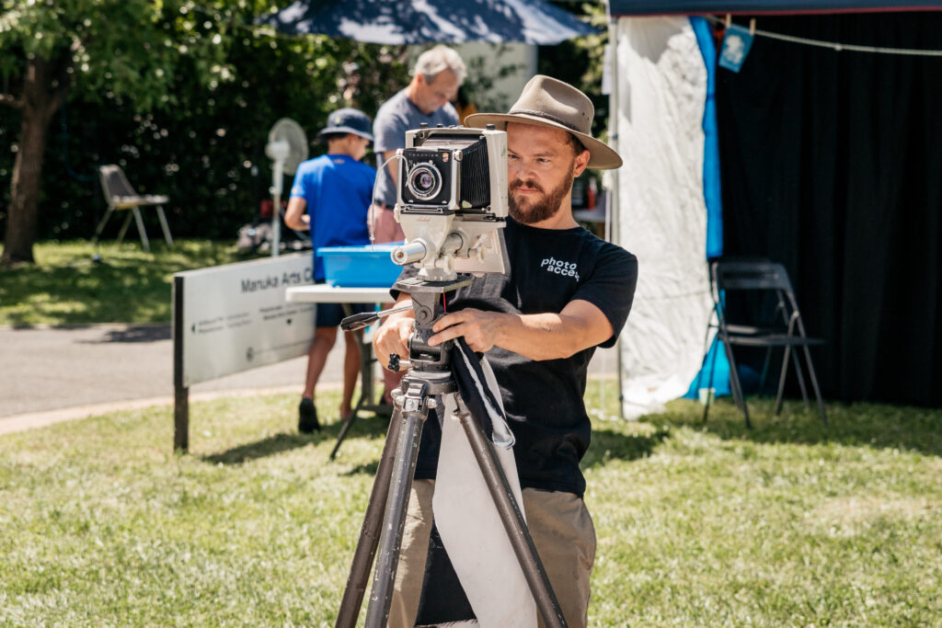An image of a man using a large format camera outside